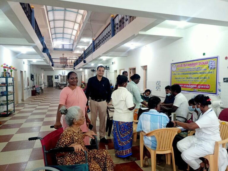 Doctors treating patients at old age home in free medical camp by MVR Medical Centre, Puducherry